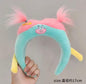 Bandolete de Peluche Azul-Turquesa com Cabelo Rosa 17 Cm